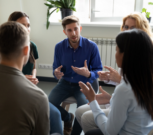 A group of adults in a brainstorming session. 
