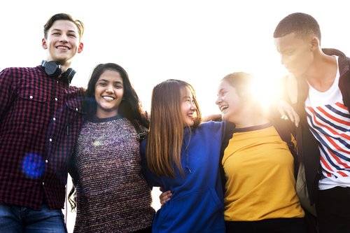 A group of teenagers with their arms around each other.