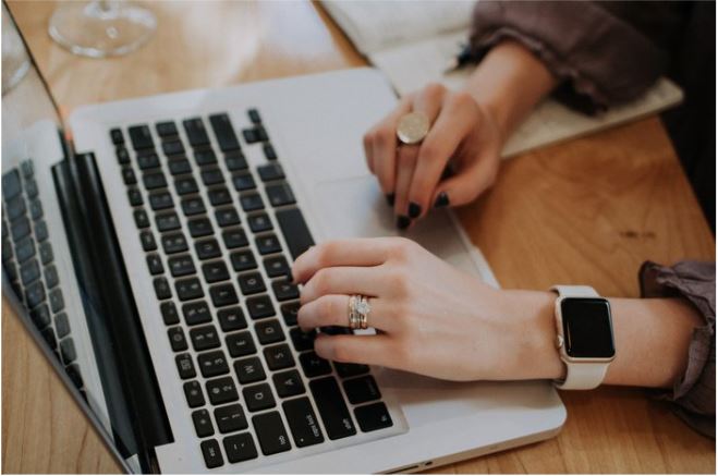 A woman working on a laptop.