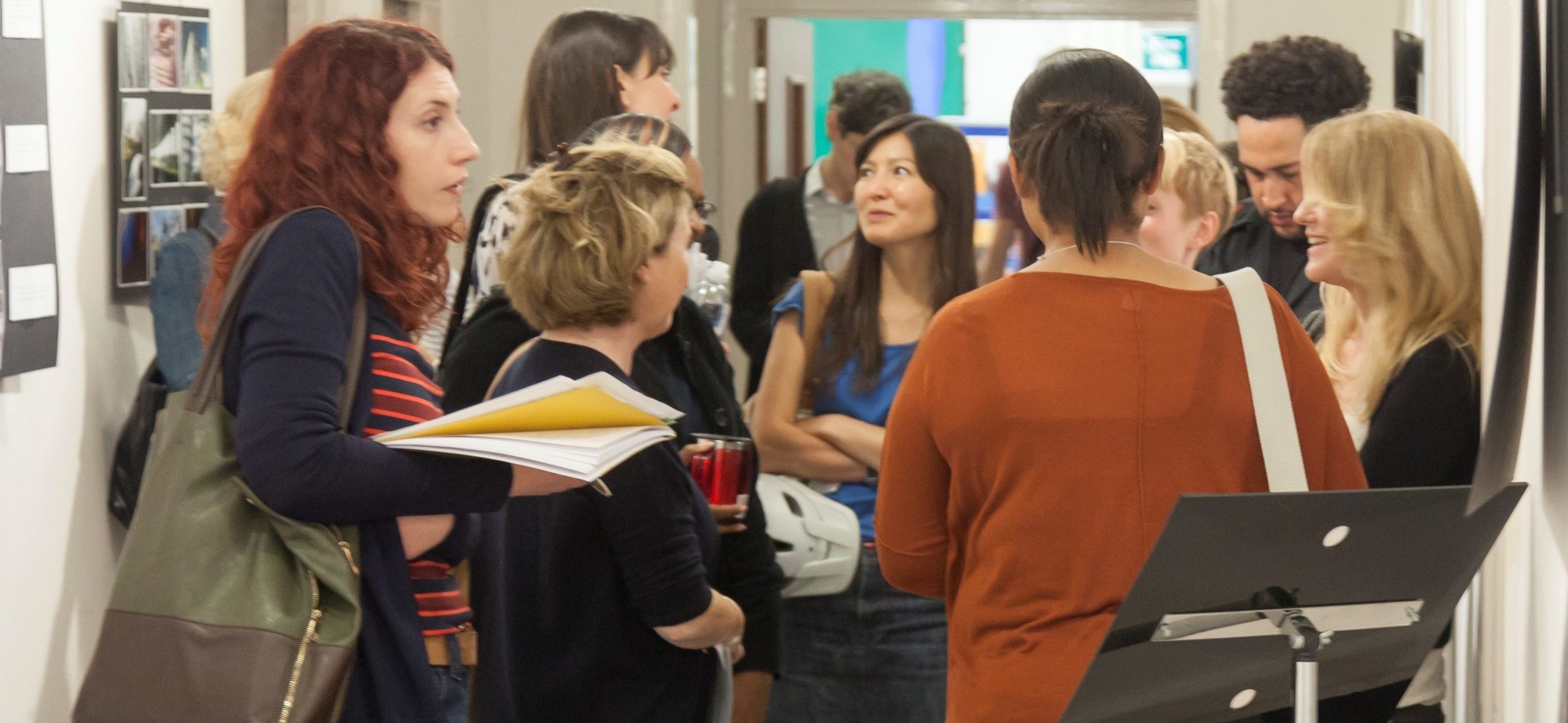 Group of students conversing in a corridor