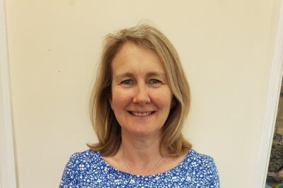 Image of a woman standing against a door
