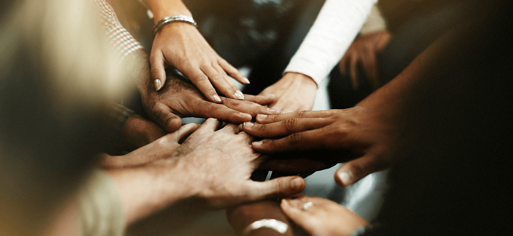 Diverse hands touching in a circle