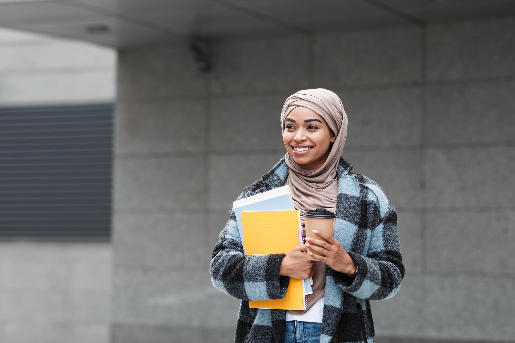 Student outside with books