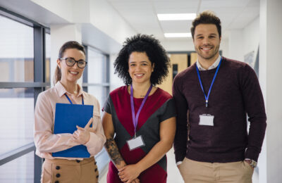 Teachers smiling in school corridor