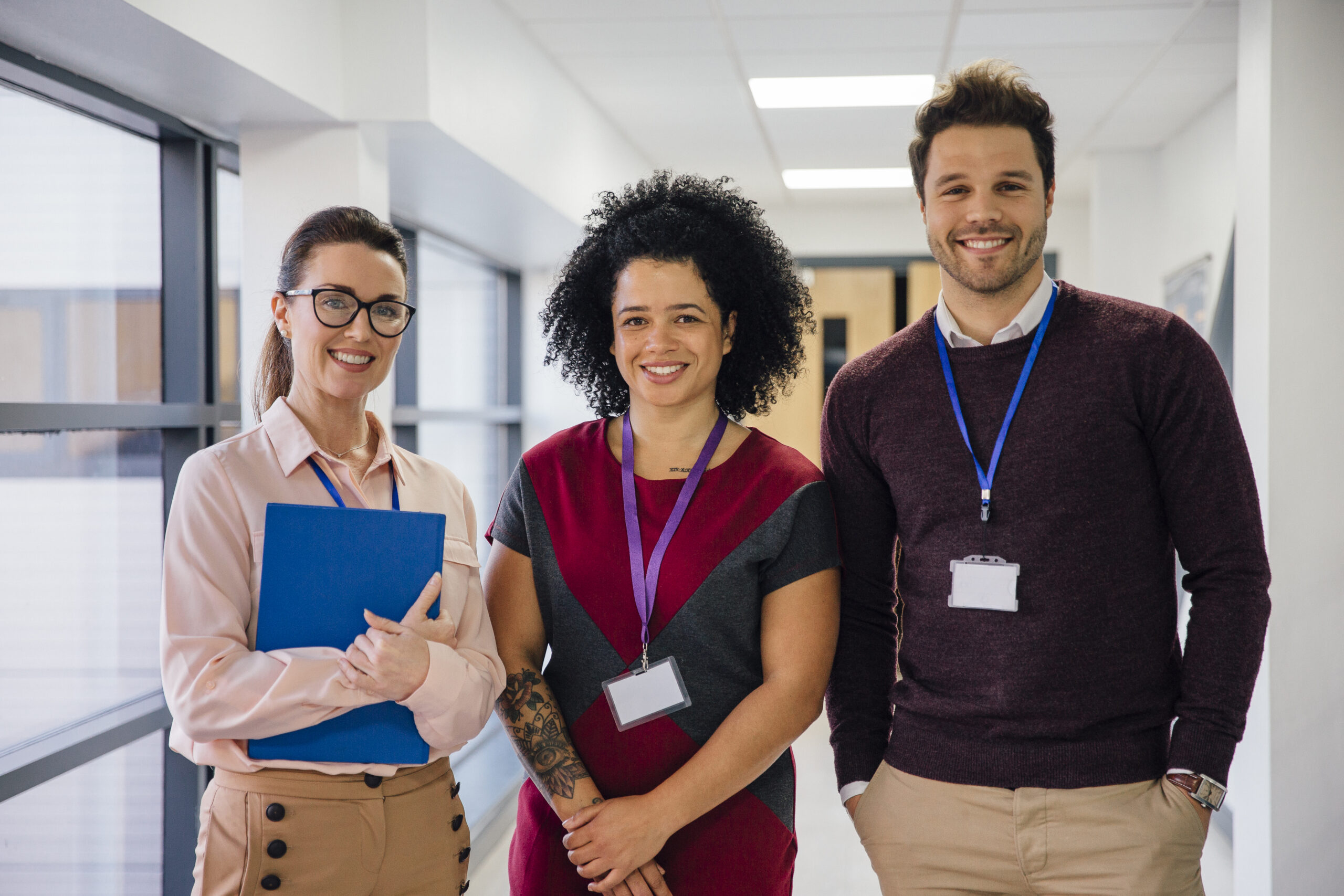 Teachers smiling in school corridor