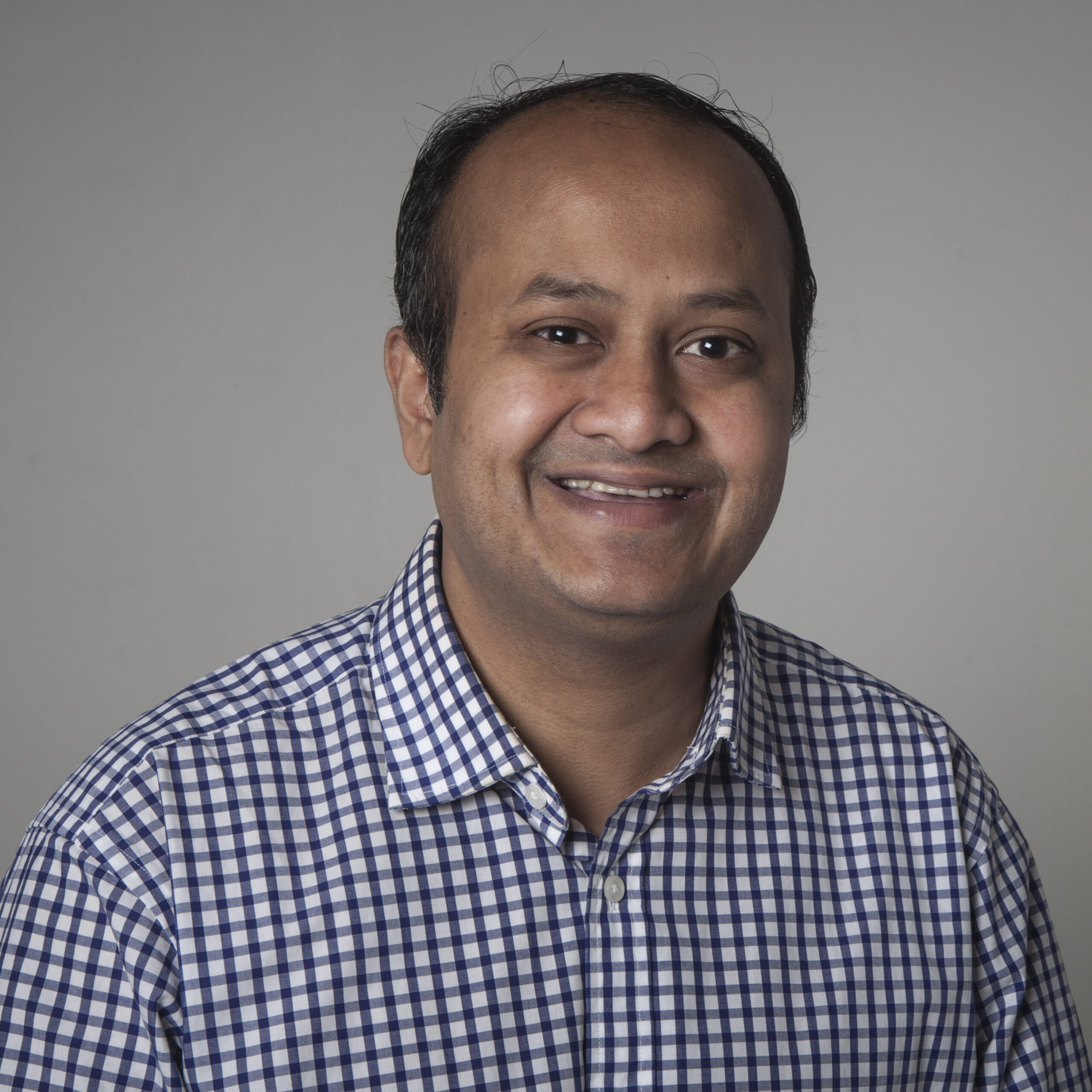 William Gomes in a checked white and blue shirt