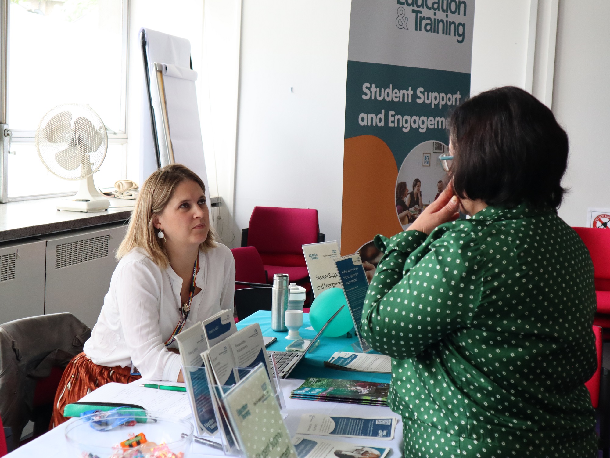 A student support adviser taking to a prospective student.