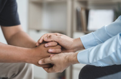 Business friend hand touch for support or encouraging together as psychological counseling wihth love and care.