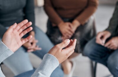 Close-up of hands during workshop discussion