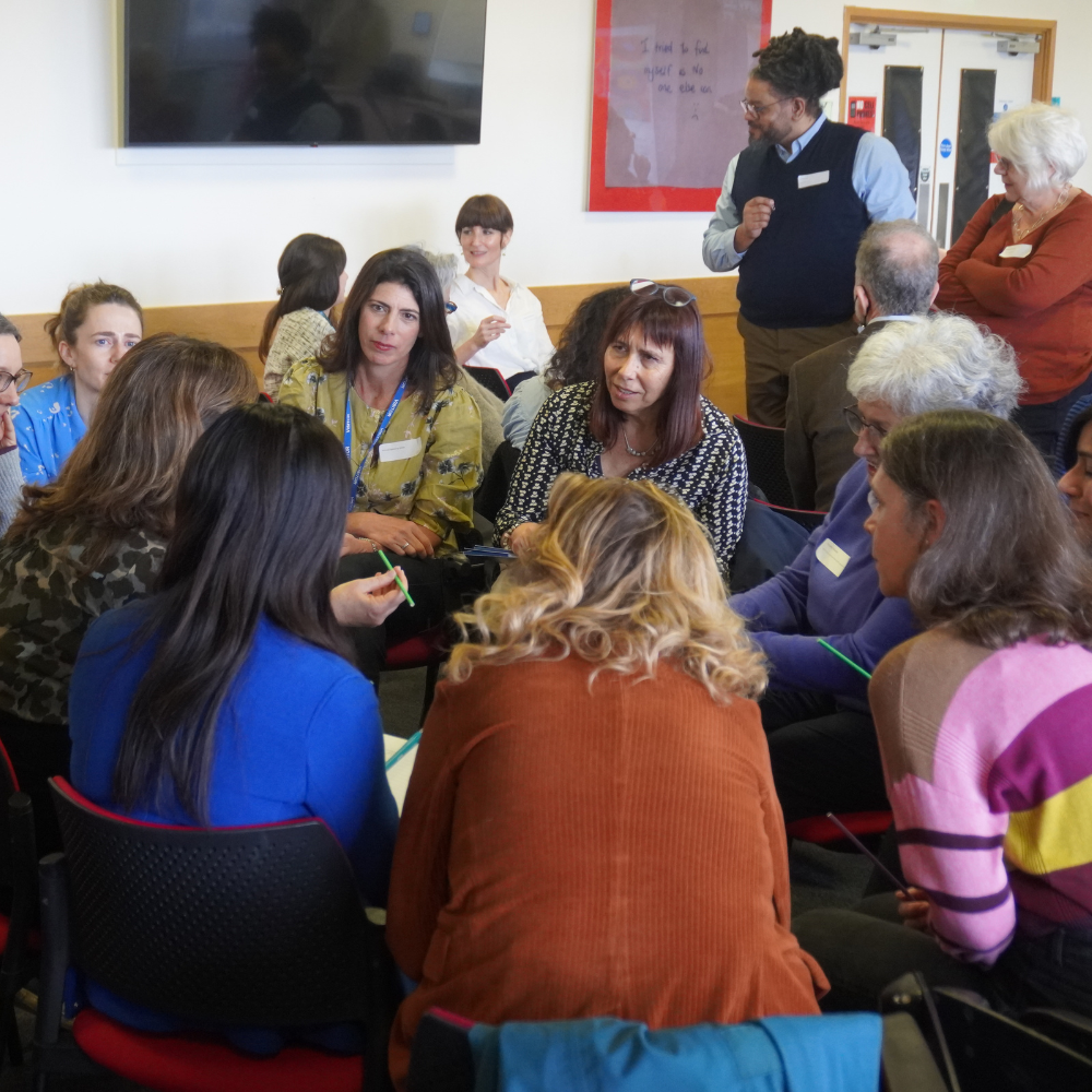 A group circle having a discussion at the 2024 Infant observation conference.