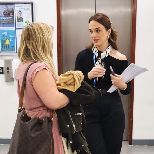 Two people talking during open day