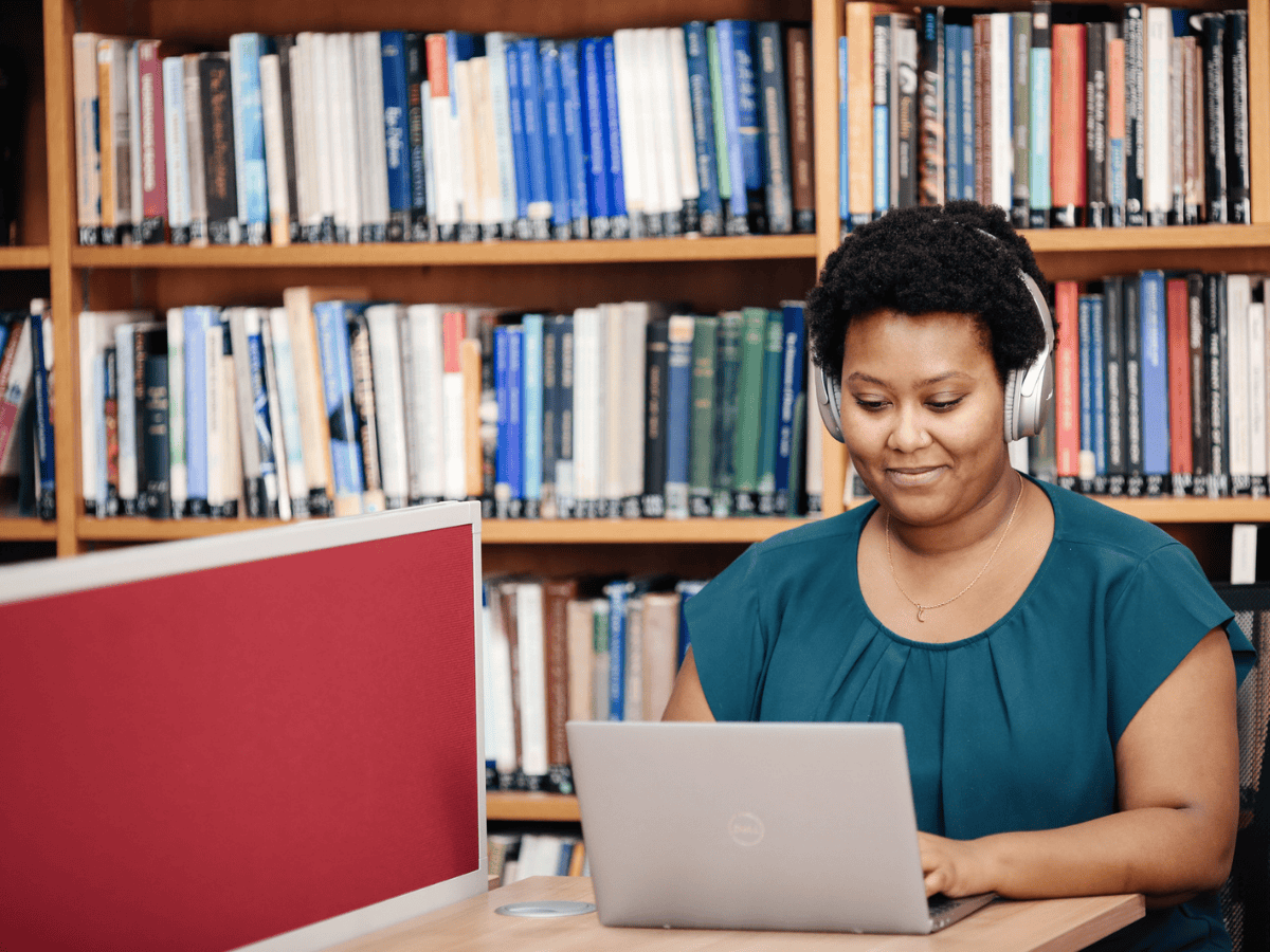 Student Working at Laptop in Library