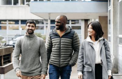 Three students walking outside The Tavistock Centre
