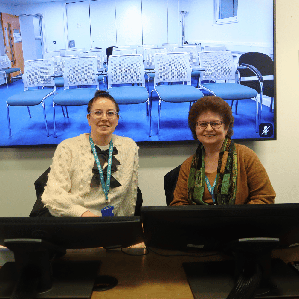 Two members of our student panel sat down and smiling at camera