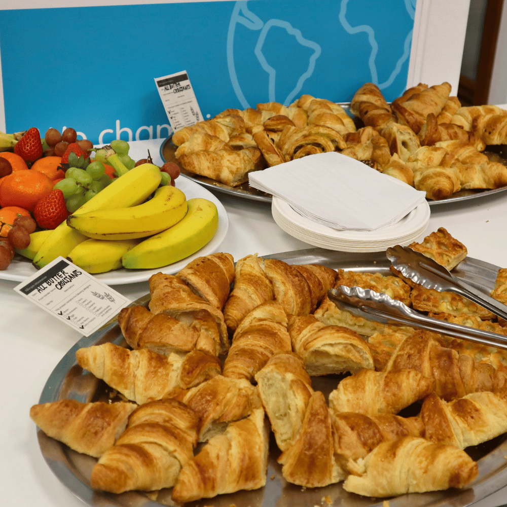 Close-up of croissants and fruit on platters