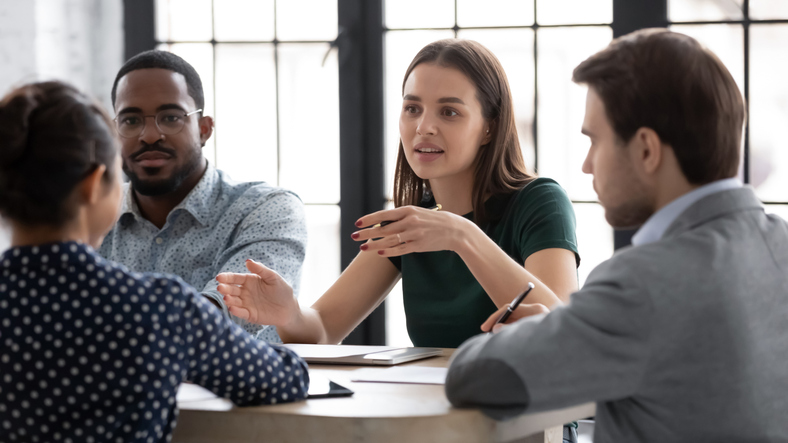 A group of young professionals discuss issues together.