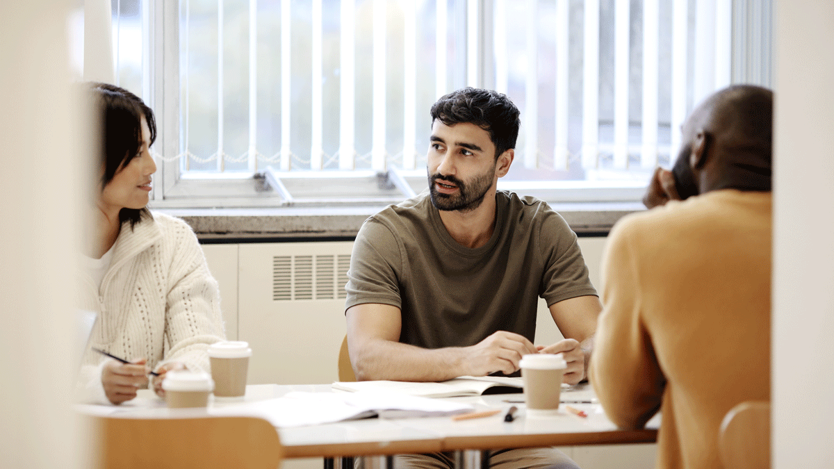 Students talking in Tavistock Centre canteen.