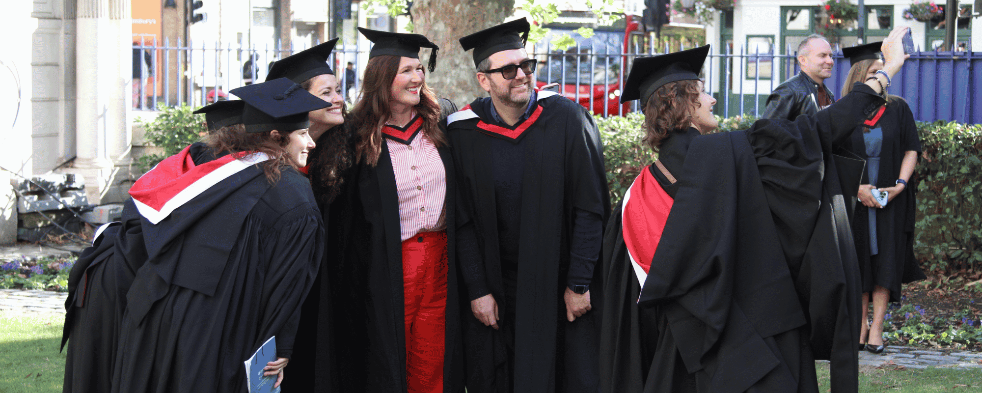 Graduates pose for a selfie outside graduation ceremony.